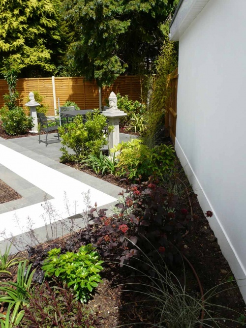 The planting when mature will soften the boundary.