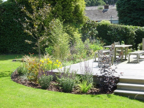 Cottage style planting to enclose raised deck.