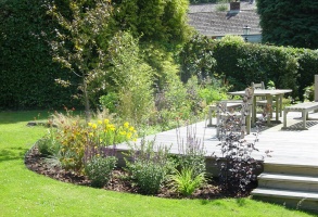 Cottage style planting to enclose raised deck.