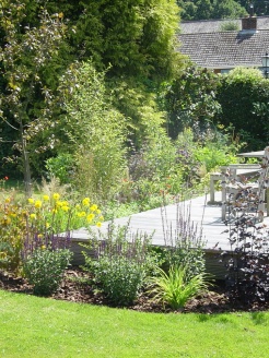 Cottage style planting to enclose raised deck.